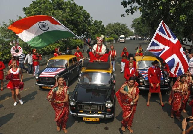 Virgin Group founder Richard Branson waves an Indian national flag while sitting atop a taxi during a promotional event in Mumbai October 26, 2012 (representational image) india uk trade, india uk civil aviation, british flights to india, indian flights to britain, diwali in london, india britain relations
