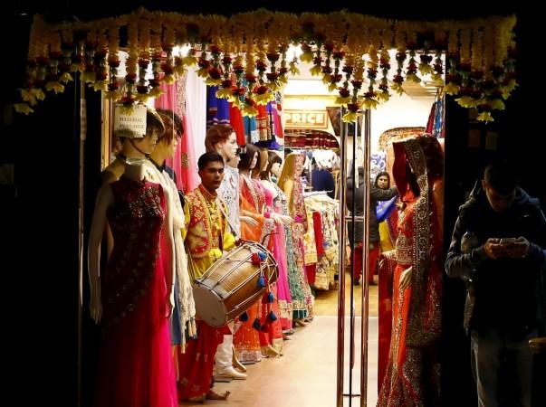 A drummer plays in a clothes shop during Diwali celebrations in Leicester, Britain November 11, 2015. india uk trade, india uk civil aviation, british flights to india, indian flights to britain, diwali in london, india britain relations