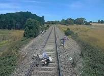 Biker forced to leap to safety after near-miss with train