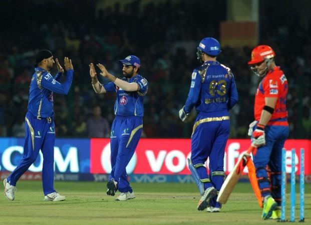 Mumbai Indians captain Rohit Sharma greets Harbhajan Singh after the fall of a wicket in the IPL. Mumbai Indians, IPl 2017, IPL 2017 auction, Rohit Sharma, Harbhajan Singh