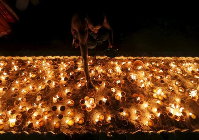 A devotee lights a lamp on the occasion of Mahashivratri. Shivaratri