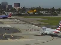 Harrison Ford cuts it close as he flies his plane just metres over American Airlines passenger jet