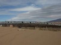 Mexican activists paint giant border wall message for Donald Trump