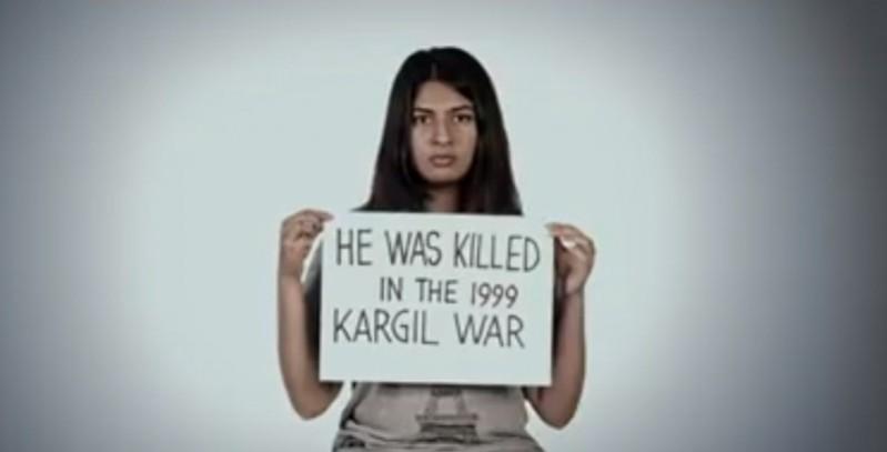 Gurmehar Kaur holds up a card that says her father Captain Mandeep Singh was killed in the 1999 Kargil War. Gurmehar Kaur
