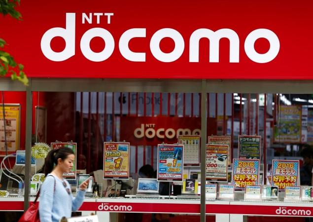 A woman walks past a brach of Japanese mobile communications company NTT Docomo in Tokyo, Japan, May 16, 2016. tata docomo dispute arbitration, tata teleservices, tata sons, tata group, delhi hc clears tata docomo deal
