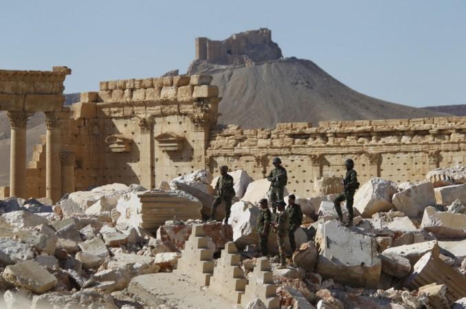 Syrian army soldiers stand on the ruins of the Temple of Bel in the historic city of Palmyra, in Homs Governorate, Syria April 1, 2016. ISIS
