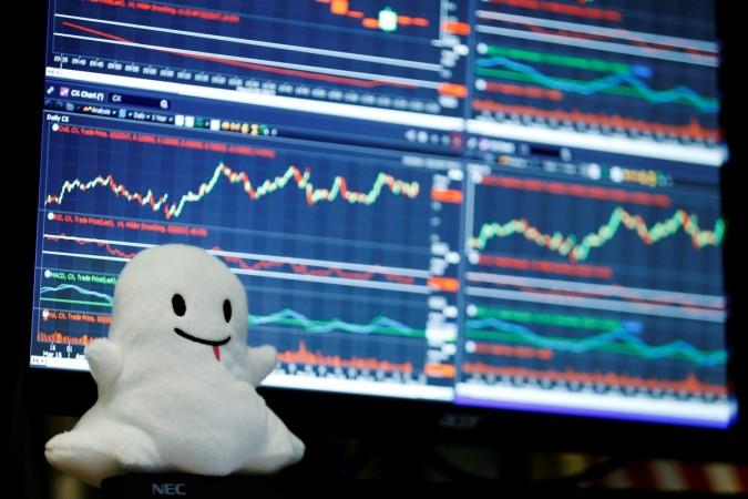 A stuffed ghost rests on a trader's screen above the floor of the New York Stock Exchange (NYSE) after Snap Inc. listed their IPO in New York, U.S., March 2, 2017. snap ipo, top quotes on snap, comments on snap valuation, snap cofounders, evan spiegel snap, bobby murhpy snap, snapchat