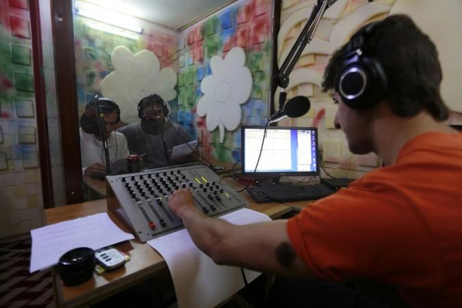 Activists sit in a studio at the Radio Fresh station in Kafranbel town in the Idlib governorate May 18, 2014 (representational image). radio city, radio city fm, music broadcast ipo, music broadcast ipo price band, music broadcast anchor investors