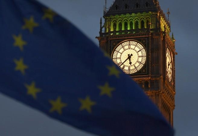 A European Union flag is waved in front of Big Ben and the Houses of Parliament in London, Britain, February 20, 2017. britain, brexit, british house of lords, european commission britain talks, House of Lords EU Financial Affairs Sub-Committee