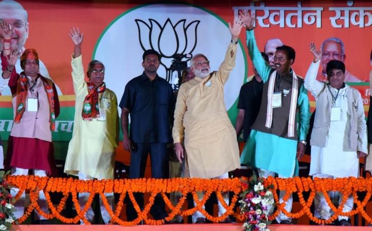 Prime Minister Narendra Modi, Uttar Pradesh BJP chief Keshav Prasad Maurya and others during a rally in Varanasi, on March 5, 2017. up elections 2017, uttar pradesh elections 2017, up election results 2017, pm modi in varanasi, amit shah bjp, bjp vs sp-congress, akhilesh yadav