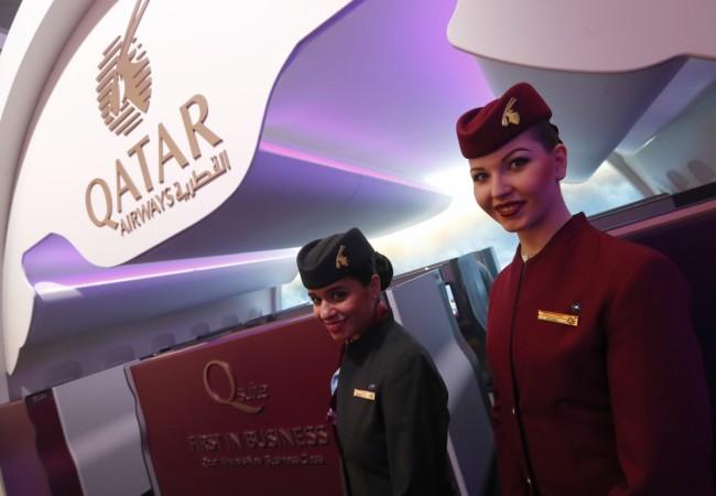 Qatar Airways stewardesses pose at the International Tourism Trade Fair ITB in Berlin, Germany, March 8, 2017. qatar airways, qatar airways to enter india, qatar airways ceo akbar baker, india fdi norms in civil aviation, spicejet share price