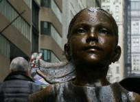 Statue of young girl stares down Wall Street bull