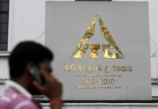A man talks on his mobile phone as he walks past an ITC office building in Kolkata September 4, 2012. itc, itc share price, its gains on gst boost, itc market cap, top 10 companies of india, india's most valuable companies