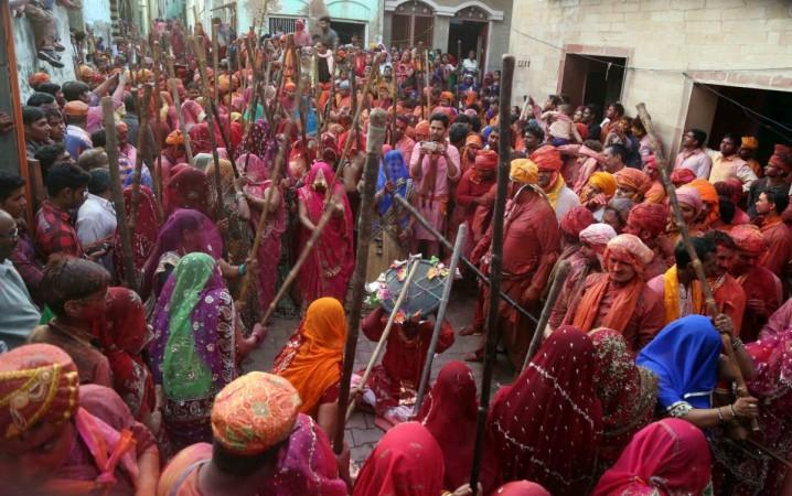 People celebrate holi 2017, happy holi 2017, stock markets to remain closed for holi, exit poll 2017, bjp win in uttar pradesh, kapda fad holi, lathmar holi