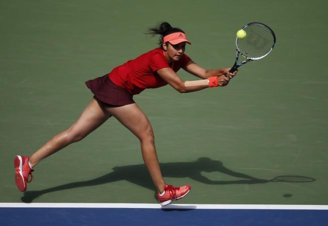 Sania Mirza of India chases down a return with playing partner Martina Hingis of Switzerland (not pictured) as they face Casey Dellacqua of Australia and Yaroslava Shvedova of Kazakhstan in the women's doubles final match at the U.S. Open Championships te