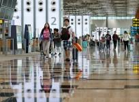 Passengers walk in Singapore's Changi Airport Terminal 3