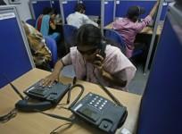 A visually impaired trainee tends to a phone call at a training call centre for the visually challenged in New Delhi October 8, 2009.