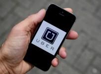 The Uber app logo is seen on a mobile telephone