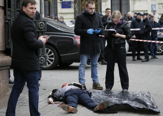 Investigators inspect the body of Denis Voronenkov, a former lawmaker of the Russian State Duma, who was shot dead, in central Kiev, Ukraine March 23, 2017. Denis Voronenkov, lawmaker, Russian State Duma, shot dead, central Kiev, Ukraine