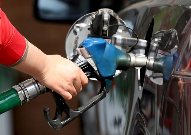 A female employee fills the tank. Fuel filling