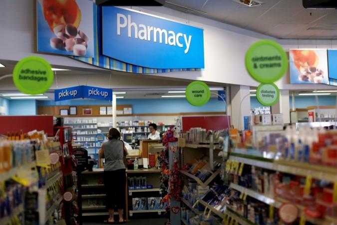 A customer waits at the counter of a CVS Pharmacy store . ims data for feb 2017, indian pharma companies, sun pharma, alkem, torrent, indian pharma firms in us, us generic sales