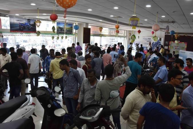 People at a 2-wheeler showroom to buy discounted vehicles after the BS III vehicles ban on sale and registration of vehicles from 1st April 2017. domestic two wheeler sales march 2017, scooter sales march 2017, bs iii vehicles, bs 3 vehicles, discount on bs iii vehicles, domestic motorcycle sales march 2017