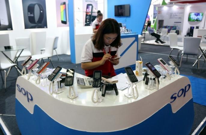 A woman at one of the counters at the Mobile fair at Pragati Maidan in New Delhi on October 22, 2016. mobile sales, mobile sales in india, handset makers, smartphones, smartphone makers in india