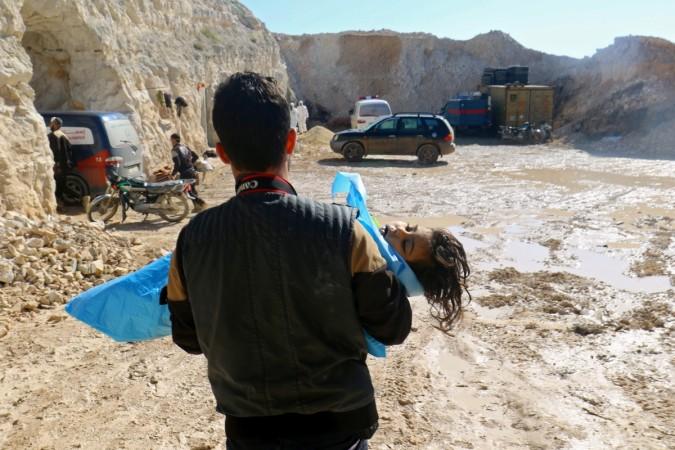 A rescue worker carrying a dead body of child after the suspected chemical attack in Syria Syria chemical attack