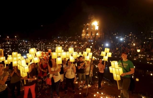 People attend way of cross procession as part of Good Friday. Good friday, jesus christ crucifixion, good friday bible, way of cross