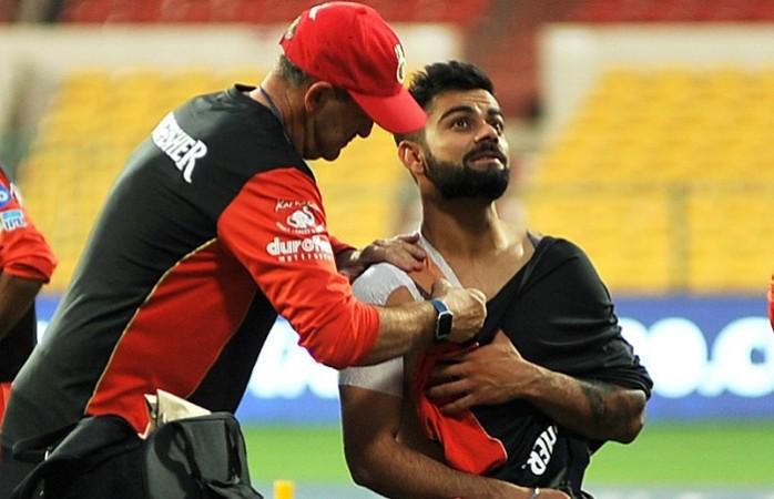 Virat Kohli gets some treatment on his shoulder after a practice session for RCB, April 12, 2017 Virat Kohli, shoulder injury, RCB, IPL 2017, Mumbai Indians