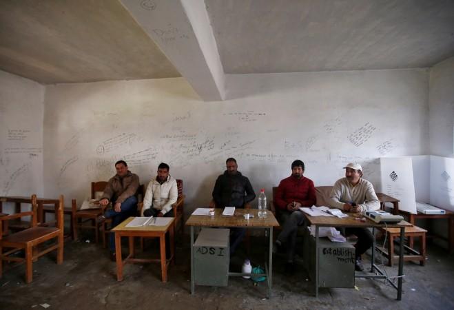 In picture: Polling officials sit as they wait for voters to turn up at an empty polling station during a re-polling in Srinagar parliamentary constituency in Wathora on the outskirts of Srinagar in Jammu and Kashmir on April 13, 2017. Srinagar bypolls