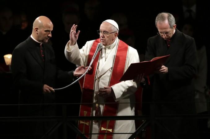 Pope Francis blesses at the end of the Via Crucis (Way of the Cross) procession during Good Friday celebrations in front of the Colosseum in Rome, Italy, April 14, 2017. Pope Francis blesses at the end of the Via Crucis (Way of the Cross) procession during Good Friday