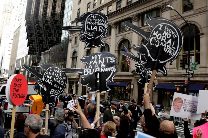 Demonstrators react as they march past Trump Tower as they protest through Manhattan demanding U.S. President Donald Trump release his tax returns. Trump tax march