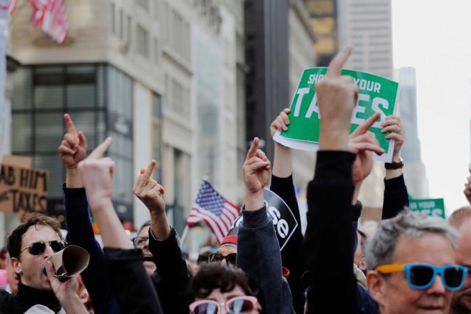 Demonstrators react as they march past Trump Tower as they protest through Manhattan demanding U.S. President Donald Trump release his tax returns Trump tax march