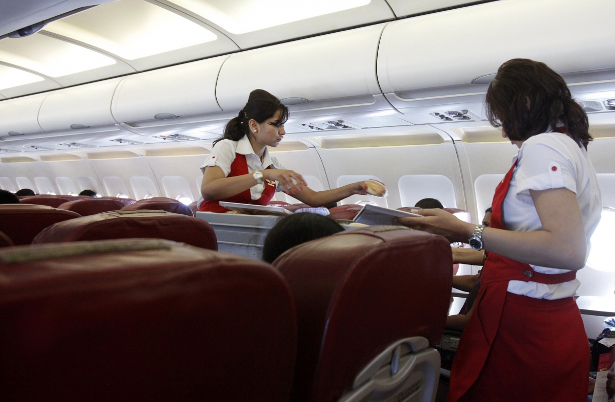 Kingfisher Airlines cabin attendants serve snacks on a flight after takeoff from Mumbai's domestic airport March 20, 2012. kingfisher airlines, kingfisher beer, vijay mallya, vijay mallya arrested in london, united breweries, usl share price