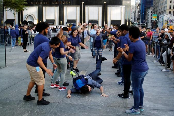 A customer falls down before going into the Apple Inc. store for buying the iPhone 7 smartphone in New York, U.S., September 16, 2016. Apple iPhone
