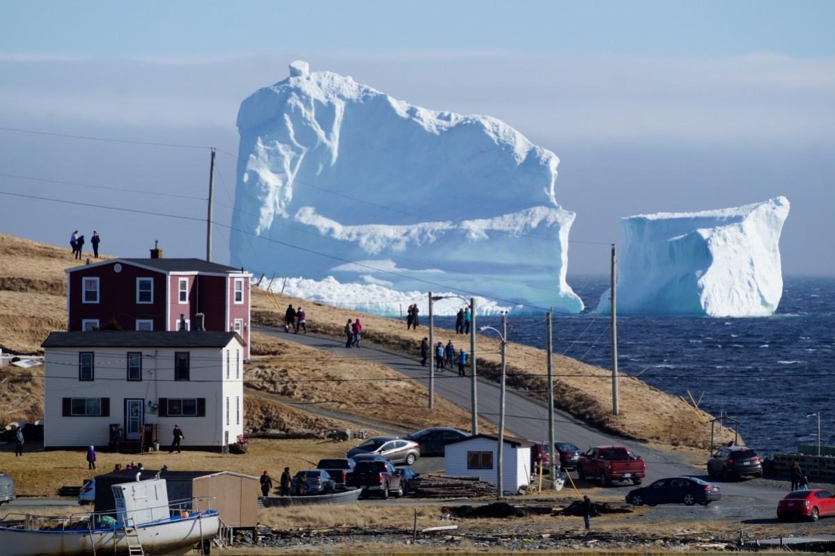 Residents view the first iceberg of the season as it passes the South Shore of Newfoundland in Canada. Canada iceberg