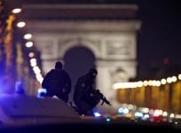 Masked police stand on top of their vehicle on the Champs Elysees Avenue