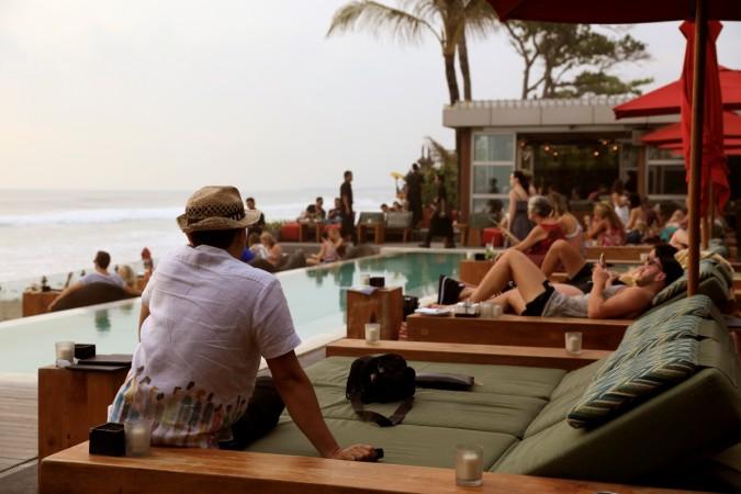Tourists sit by the pool at Ku De Ta bar in Seminyak, Bali March 22, 2017. bali islands, bali, indonesia, tourism in bali, tourists in bali, balinese hindu men, beaches of bali, bali beach, tripadvisors