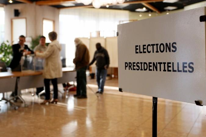 People line up to vote in the first round of 2017 French presidential election at a polling station in Vaulx-en-Velin near Lyon, France. French elections