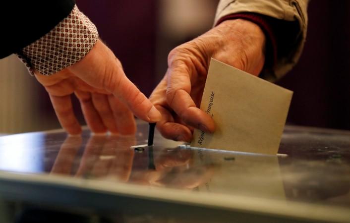 A voter casts his ballot at the polling station to vote in the first round of 2017 French presidential election in Paris, France. French polls