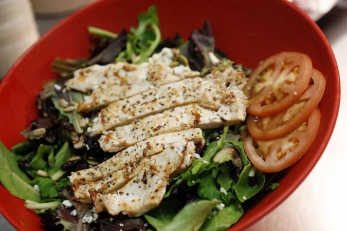 A harvest salad loaded with chicken. tomatoes and greens Salad