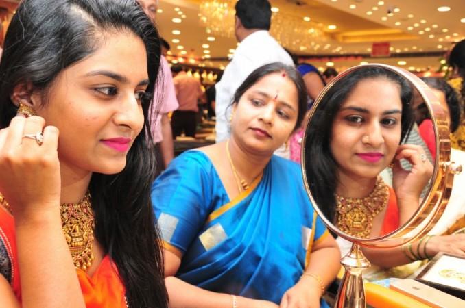 Women buy gold on akshaya tritiya, akshaya tritiya 2017, gold buying, sovereign gold bonds, sgb, gold bond scheme, gold prices in india, titan share price