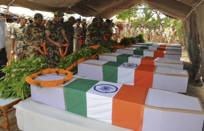 Central Reserve Police Force (CRPF) personnel place garlands on the flag-draped coffins of their colleagues, who were killed in an explosion, during a ceremony in Ranchi May 4, 2011 Central Reserve Police Force (CRPF) personnel place garlands on the flag-draped coffins of their colleagues, who were killed in an explosion, during a ceremony in Ranchi May 4, 2011