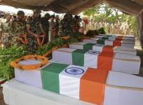 Central Reserve Police Force (CRPF) personnel place garlands on the flag-draped coffins of their colleagues, who were killed in an explosion, during a ceremony in Ranchi May 4, 2011