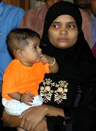 Bilkis Yakub Rasool, holds her six-month-old daughter Fatima, during a news conference in the western city of Ahmedabad, August 8, 2004. Bilkis Yakub Rasool, holds her six-month-old daughter Fatima, during a news conference in the western Indian city of Ahmedabad, August 8, 2004.