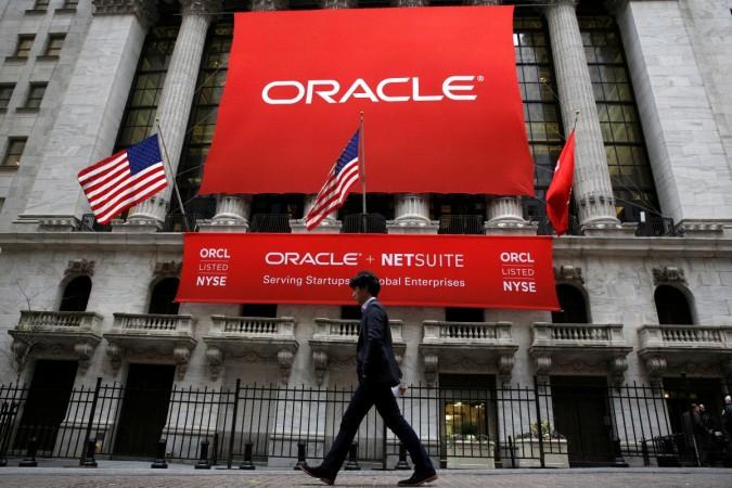An Oracle banner hangs outside the New York Stock Exchange (NYSE) in New York City, U.S., January 18, 2017. oracle, oracle ceo, h1 b visa, misuse of h1 b visa, indian students in us, donald trump on misuse of h-1 b visa