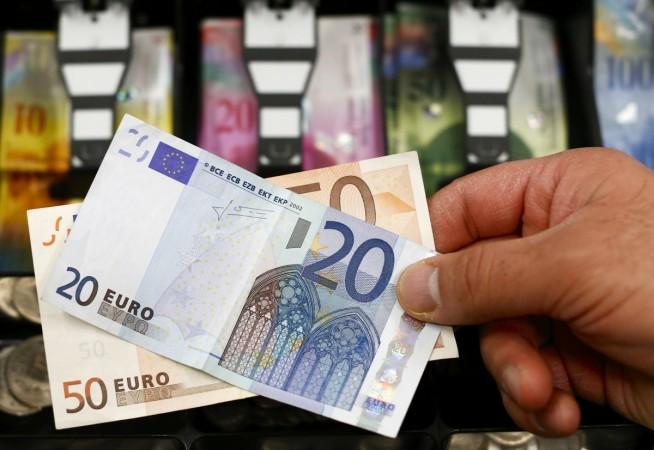 A 20 and 50 Euro bank note are seen in front of a cash drawer with Swiss francs in Bern January 16, 2015. french elections 2017, french polls 2017, Élysée palace, centrist emmanuel macron, far right marine le pen, french economy, india france bilateral trade, paris fashion, fashion shows in paris