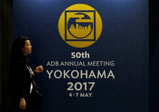 A woman walks at the site of Asian Development Bank (ADB)'s annual general meeting in Yokohama, south of Tokyo, Japan May 4, 2017. adb, adb 50th agm, fm arun jaitley, adb regional hub in delhi, finance ministers of asean, asean summit