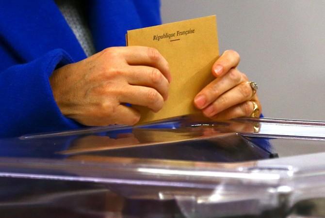 A French national living in Australia prepares to cast her vote in the presidential poll at a polling booth located at a school in Sydney, Australia Fernch polls